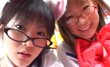 Two angelical japanese teenagers play around with cameras